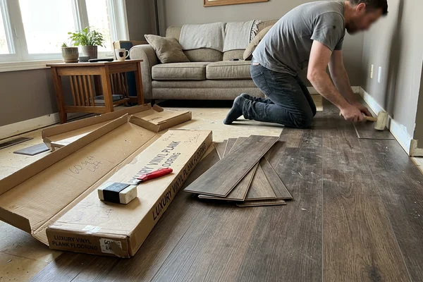 Boxes of commercial luxury vinyl plank beside a part-laid floor