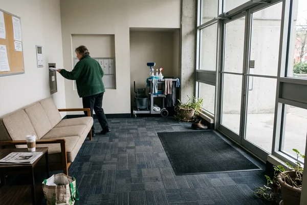 Condo lobby with modular carpet tile and recessed entrance matting at the doors