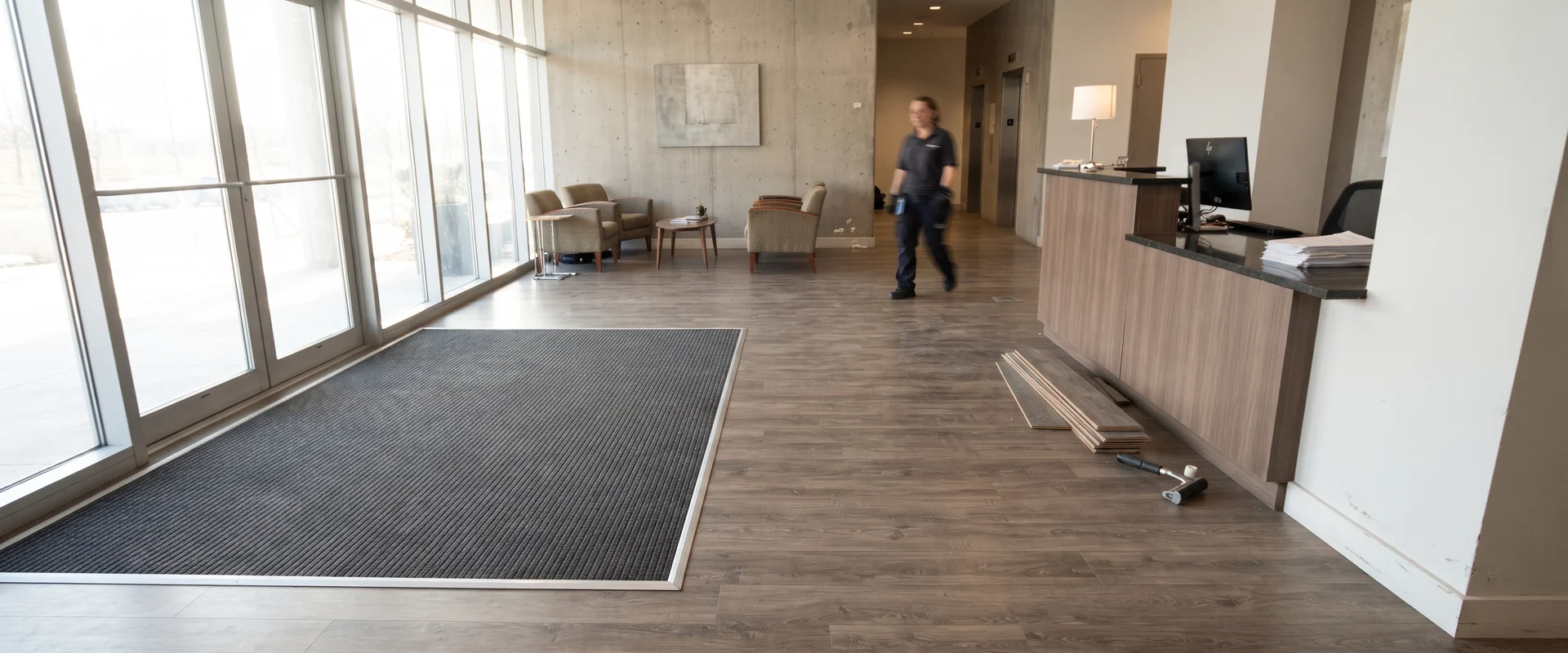 Completed commercial lobby floor with recessed entrance matting and luxury vinyl tile